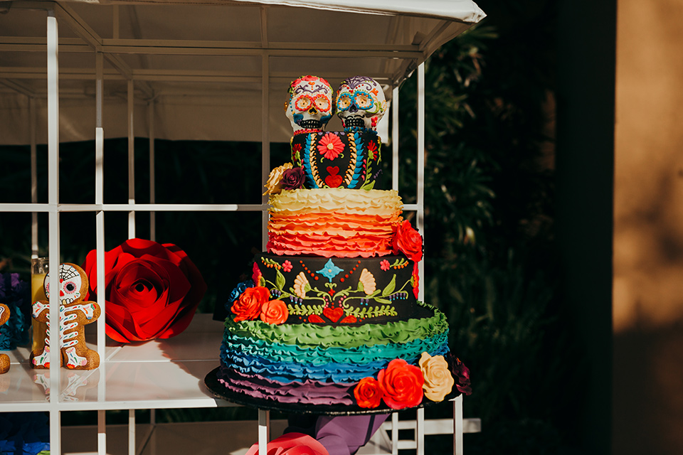 dia-de-los-muertos-shoot-cake-three-tiers-with-with-colorful-frosting-and-floral-embellishments