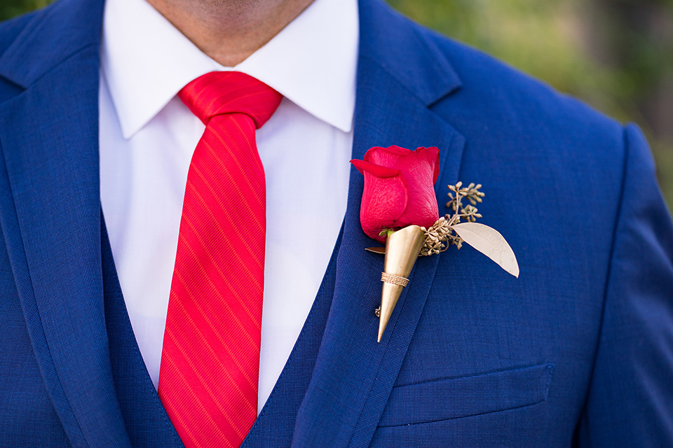 wonder-woman-meets-superman-close-up-on-suit-blue-suit-with-a-white-shirt-and-red-long-tie-with-red-floral-boutionniere