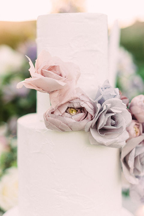 Inn-at-rancho-santa-fe-shoot-close-up-on-cake-white-two-tiered-cake-with-lavander-sugar-flowers