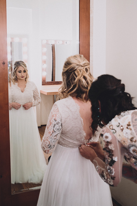 amanda-and-codys-wedding-at-the-1909-bride-and-groom-walking-away-bride-in-an-a-line-dress-with-a-tulle-skirt-and-lace-long-sleeve-bodice