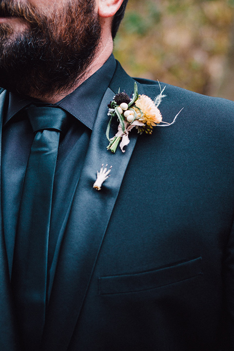 amanda-and-codys-wedding-at-the-1909-close-up-on-groom-groom-in-all-black-shawl-lapel-tuxedo-and-a-small-hand-pin-on-the-lapel