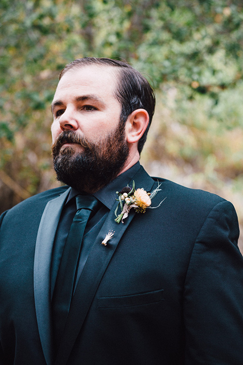 amanda-and-codys-wedding-at-the-1909-groom-in-all-black-shawl-lapel-tuxedo-and-a-small-hand-pin-on-the-lapel