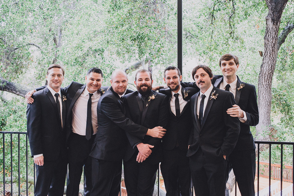 amanda-and-codys-wedding-at-the-1909-groomsmen-groom-in-all-black-shawl-lapel-tuxedo-with-black-shirt-groomsmen-in-same-tuxedo-with-a-white-shirt