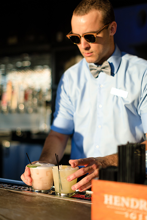 evolution-of-style-party-bar-tender-with-sunglasses-on-and-a-bow-tie-serving-cocktails-at-the-fifth-restaurant