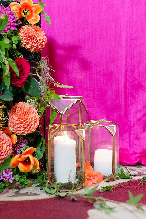 Exquisite-weddings-magazine-candle-and-floral-décor-hot-pink-table-linen-with-orange-and-green-florals-and-white-candles