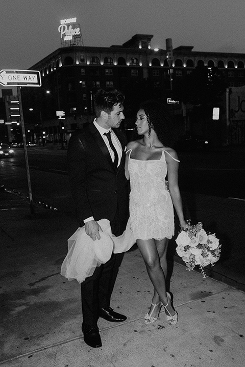  downtown Los Angeles elopement with the bride in a mini dress and the groom in a black tuxedo – couple looking at each other 