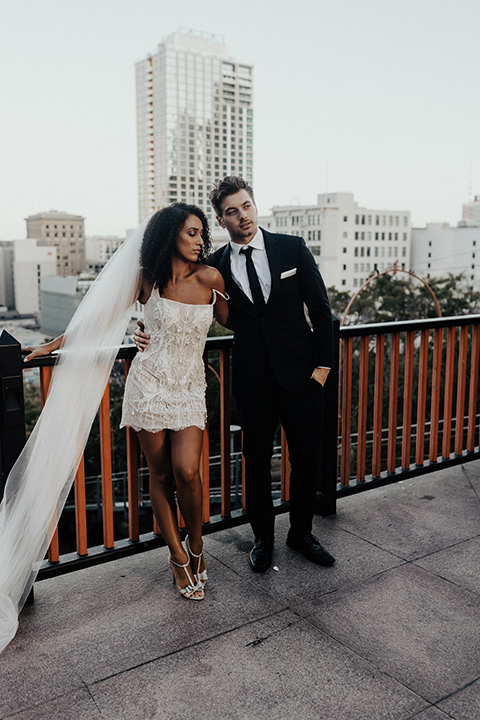  downtown Los Angeles elopement with the bride in a mini dress and the groom in a black tuxedo – by Angeles Landing 