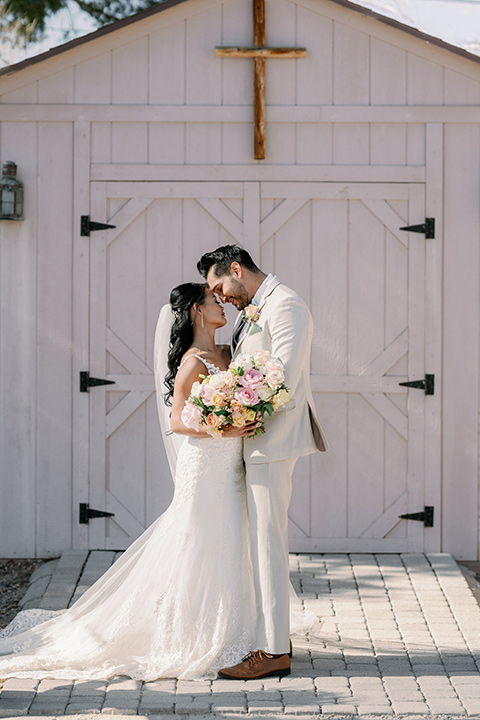  a garden romance wedding inspo with the bride in a luxe lace gown and the groom in a tan suit - ceremony 