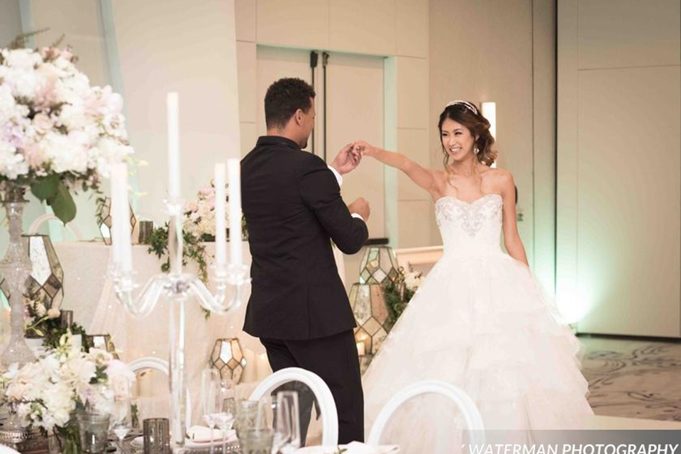 Classic glamour wedding shoot at the avenue of the arts hotel bride strapless ball gown with beaded detail on top with sweetheart neckline and groom black tuxedo with white dress shirt and long silver tie with matching vest and pocket square dancing