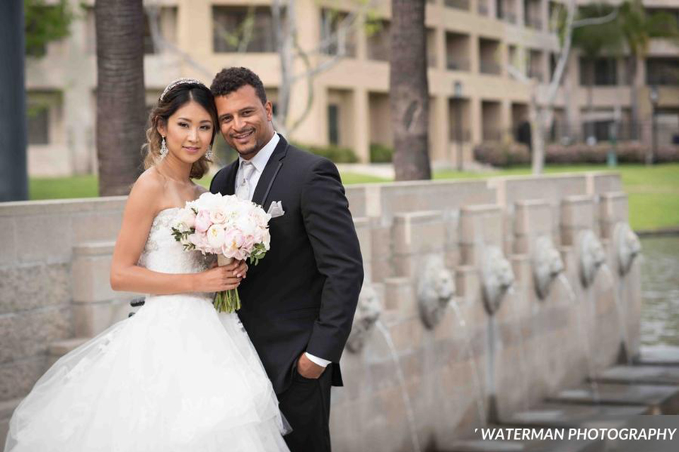 Classic glamour wedding shoot at the avenue of the arts hotel bride strapless ball gown with beaded detail on top with sweetheart neckline and groom black tuxedo with white dress shirt and long silver tie with matching vest and pocket square