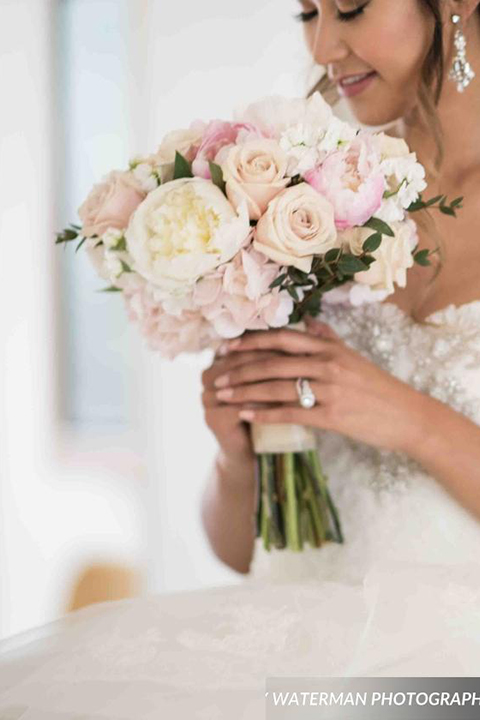 Classic glamour wedding shoot at the avenue of the arts hotel bride strapless ball gown with beaded detail on top with sweetheart neckline holding white and pink floral bridal bouquet