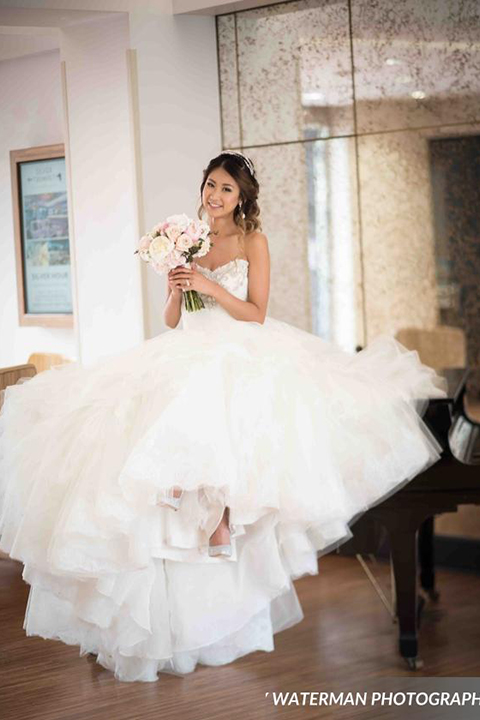 Classic glamour wedding shoot at the avenue of the arts hotel bride strapless ball gown with beaded detail on top with sweetheart neckline holding white and pink floral bridal bouquet