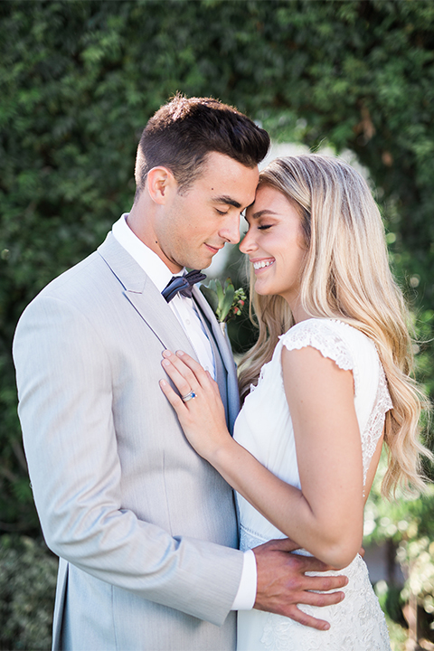 Balboa Bay Resort Wedding Bride and Groom Smiling With Eyes Closed Grey Suit Navy Bow Tie Brown Shoes