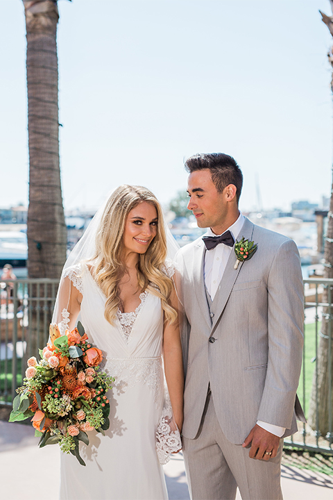 Balboa Bay Resort Wedding Bride and Groom Smiling Grey Suit Navy Bow Tie Brown Shoes