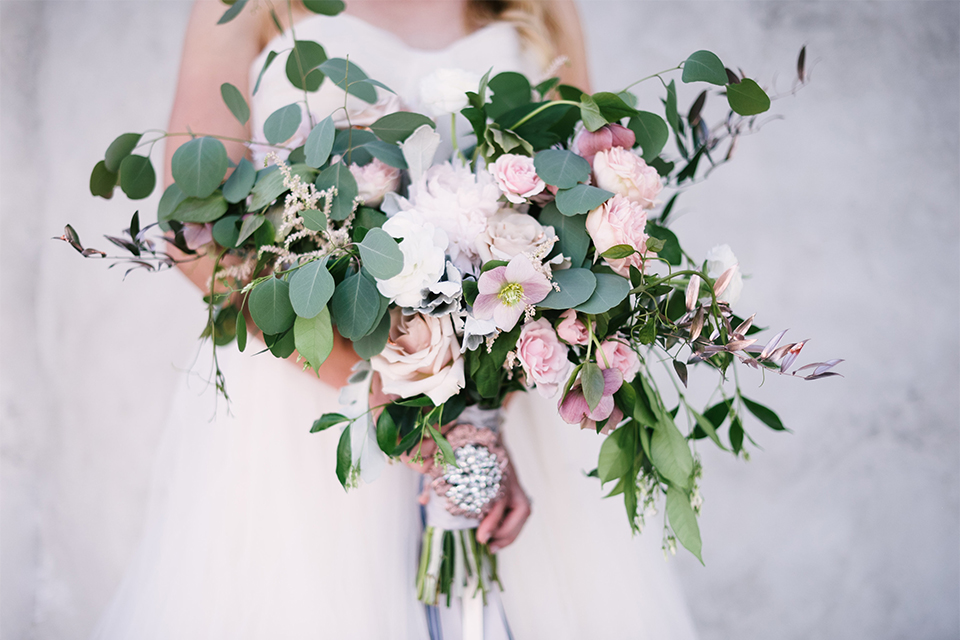 Orange county outdoor wedding at old ranch country club bride strapless ballgown with a sweetheart neckline and beaded detail holding light pink and green floral bridal bouquet close up