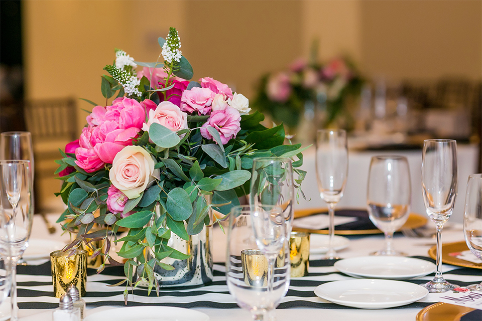 San juan capistrano outdoor wedding at the plaza de magdelena table set up black and white table linen with gold place settings and black linen napkins with white and black calligraphy menu with flower decor and glassware with white and pink flower centerpiece decor and black and white chiavari chairs