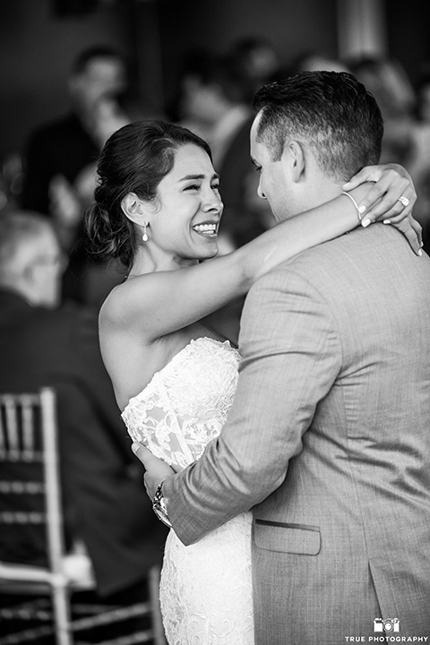 skybox-venue-wedding-bride-and-groom-dancing-bride-in-strapless-gown-with-beaded-bodice-groom-in-light-grey-suit-with-ivory-tie