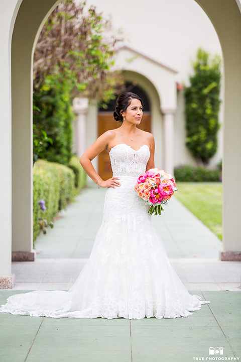 skybox-venue-wedding-bride-standing-bride-in-strapless-gown-with-beaded-bodice-groom-in-light-grey-suit-with-ivory-tie