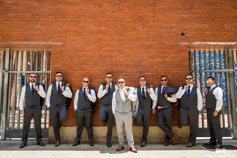 skybox-venue-wedding-groomsmen-groomsmen-photos-groomsmen-in-dark-grey-suits-groom-in-light-grey