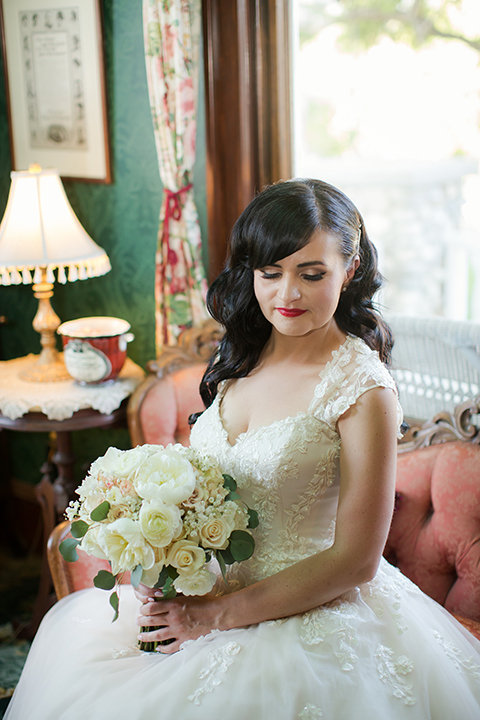 Orange county outdoor summer wedding at the heritage museum bride ball gown with lace straps and a sweetheart neckline with a short tulle skirt and long veil holding white floral bridal bouquet