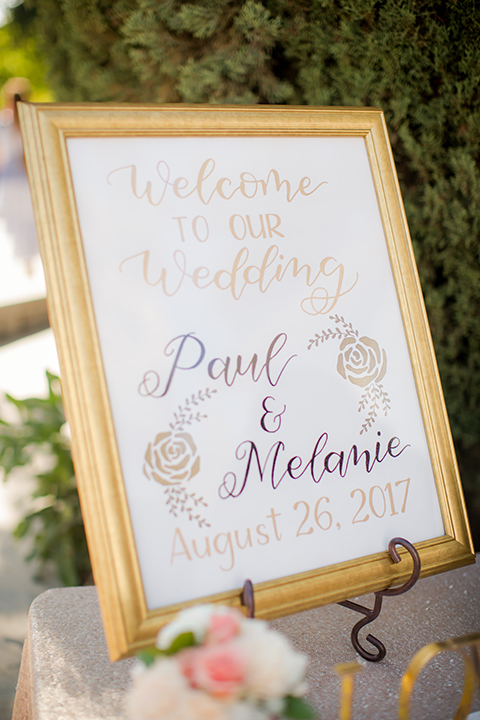 Orange county outdoor summer wedding at the heritage museum wedding welcome sign with white sign and gold frame with gold cursive writing on stand wedding photo idea for ceremony decor