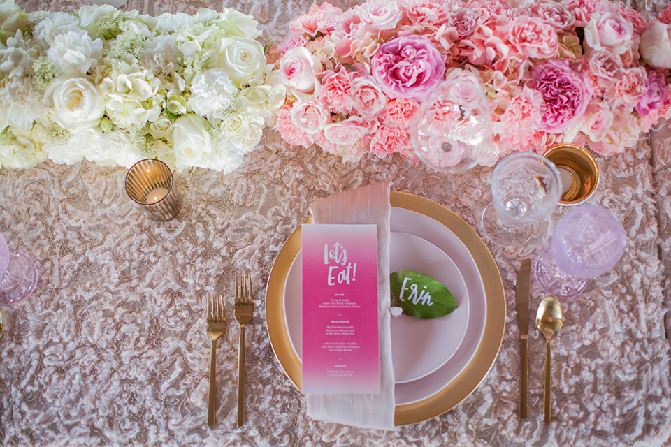 San clemente beach wedding shoot at ole hanson beach club table set up with white table floral linen and blush pink flower centerpiece decor with white and gold place settings with pink menus and glassware