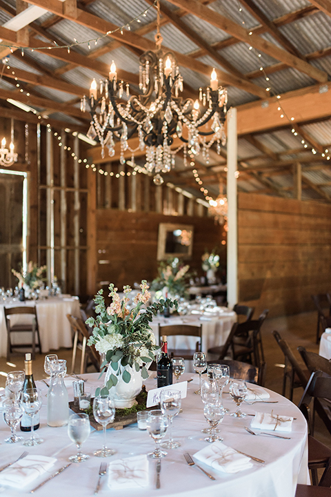 California outdoor wedding at the rancho san antonio reception decor white sweetheart table with animal decor and white chairs with brown wood mr and mrs signs with white place settings and table number wedding photo idea for reception