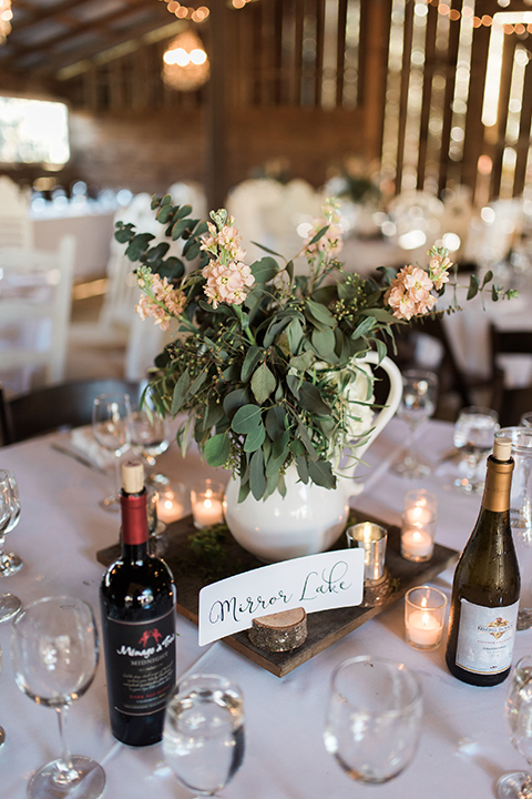 California outdoor wedding at the rancho san antonio reception decor white sweetheart table with animal decor and white chairs with brown wood mr and mrs signs with white place settings and table number wedding photo idea for reception