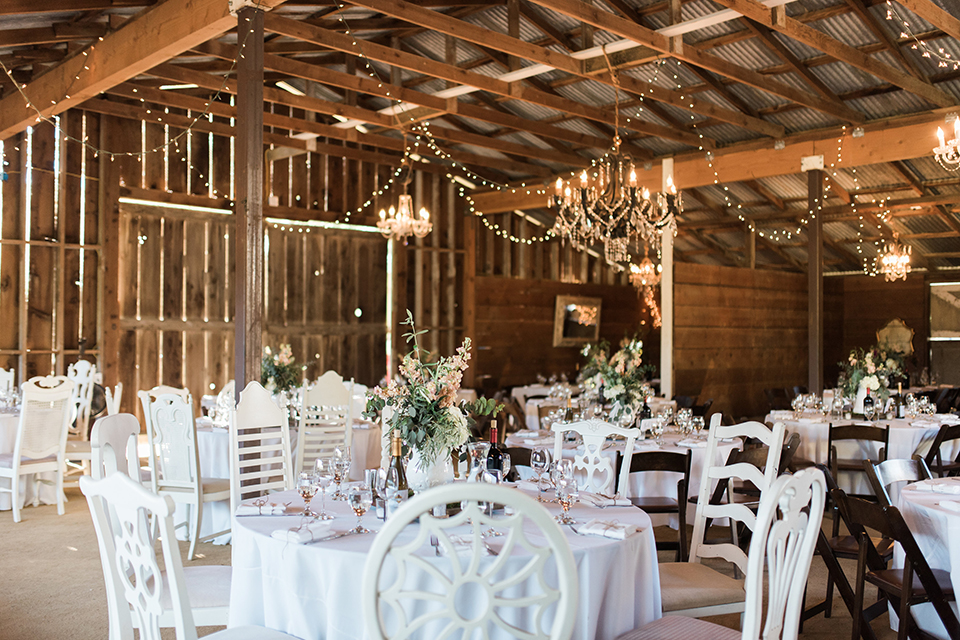 California outdoor wedding at the rancho san antonio reception decor white sweetheart table with animal decor and white chairs with brown wood mr and mrs signs with white place settings and table number wedding photo idea for reception