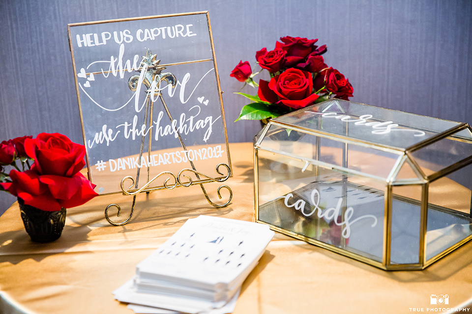 San diego glamorous wedding at the us grant hotel wedding reception decor glass sign with gold trim and white calligraphy writing for sign and card box with red flower decor wedding photo idea