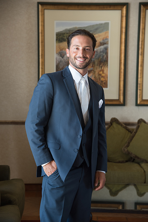 Orange county outdoor wedding at the oak canyon nature center groom slate blue notch lapel suit with a matching vest and white dress shirt with a long white tie and white floral boutonniere