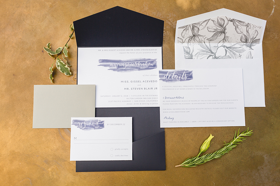 San diego wedding at the hilton bayside white and navy wedding invitations with blue writing on gold background with flower decor wedding photo idea for invitations