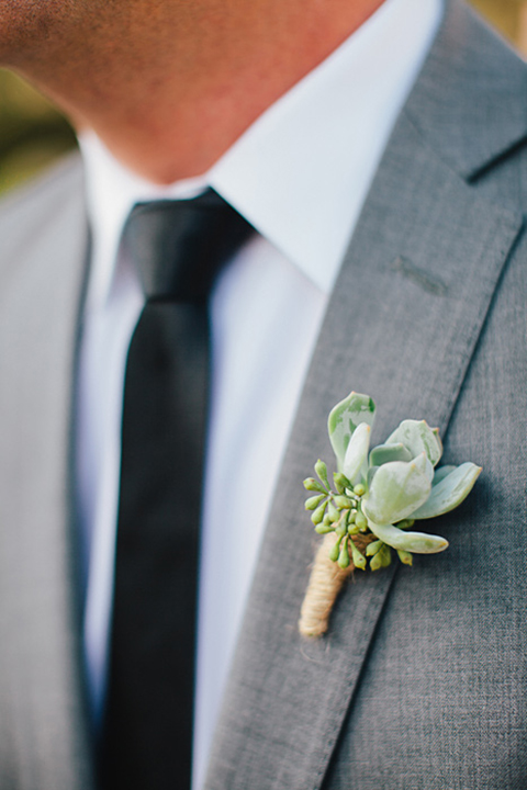 Boutonniere-style-grey-notch-lapel-suit-with-a-long-black-tie-and-green-succulent-boutonniere