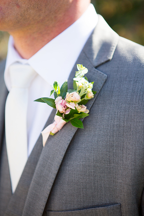 Boutonniere-style-grey-notch-lapel-suit-with-a-white-long-tie-and-a-white-simple-floral-boutonniere