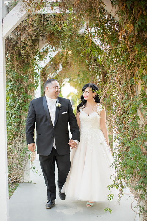 Orange county outdoor summer wedding at the heritage museum bride ball gown with lace straps and a sweetheart neckline with a short tulle skirt and long veil with groom black shawl lapel tuxedo with a white dress shirt and white vest with a white tie and white floral boutonniere