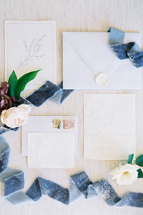 California outdoor wedding shoot at glamis sand dunes white wedding invitations with blue ribbon decor and white envelopes with white seals and white and green floral decor wedding photo idea