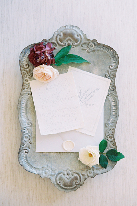 California outdoor wedding shoot at glamis sand dunes white wedding invitations with blue ribbon decor and white envelopes with white seals and white and green floral decor on vintage silver tray wedding photo idea