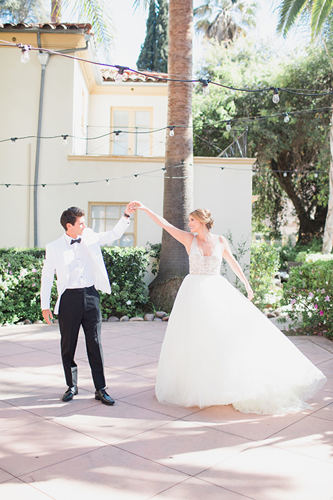 Pasadena outdoor wedding at the maxwell house bride mermaid style gown with thin spaghetti straps and beaded detail with a sweetheart neckline and groom white dinner jacket with black tuxedo pants and a white dress shirt with a black bow tie dancing