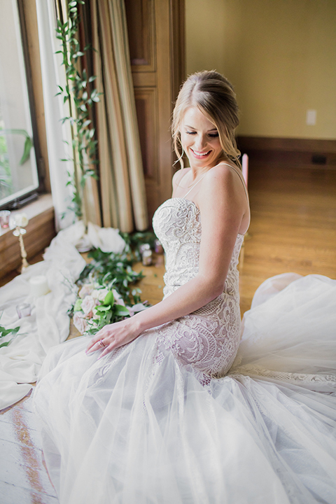 Pasadena outdoor wedding at the maxwell house bride form fitting mermaid style gown with thin spaghetti straps and beaded detail sitting on ground with candle decor close up