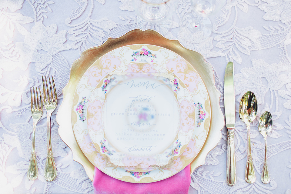 Pasadena outdoor wedding at the maxwell house table set up blush pink lace table linen with greenery floral decor and white vintage chairs with candles and flower centerpieces with white floral and gold place settings with gold silverware and pink decor