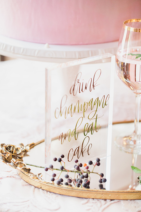 Pasadena outdoor wedding at the maxwell house dessert table set up with wedding cake and wedding cake sign glass sign with calligraphy writing on gold tray for wedding cake