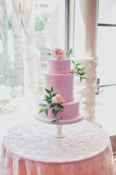 Pasadena outdoor wedding at the maxwell house dessert table set up with wedding cake and wedding cake sign glass sign with calligraphy writing on gold tray for wedding cake three tier pink wedding cake with flower and greenery decor on top and on sides wedding photo idea