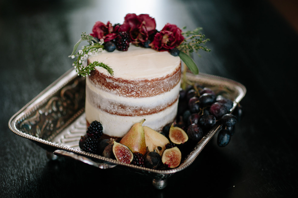 Southern-california-wedding-at-the-ebell-of-long-beach-wedding-cake-small-two-tiered-cake-with-simple-design-of-figs-and-flowers-as-decor