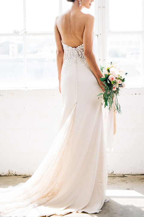 FD-Studios-bridal-gown-from-behind-bride-wearing-a-flowing-strapless-gown-with-a-lace-bodice