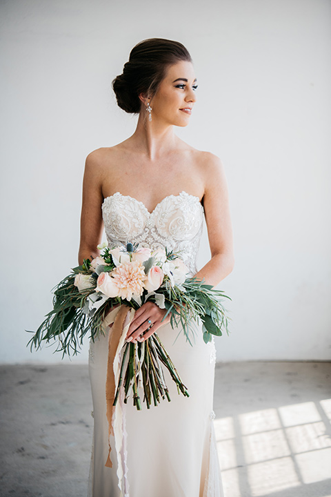 FD-Studios-bride-looking-to-the-side-bride-wearing-a-flowing-strapless-gown-with-a-lace-bodice