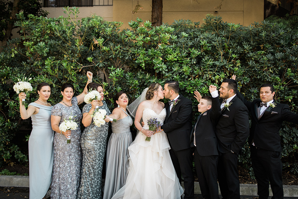 Avenue-of-the-arts-wedding-all-of-the-bridal-party-bridesmaids-in-grey-dresses-groomsmen-in-black-tuxeos-bride-in-tulle-ball-gown-with-beaded-bodice-and-beaded-headband-groom-inblack-tuxedo-with-a-silver-vest-and-silver-bowtie