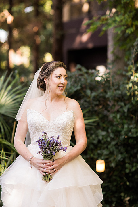 Avenue-of-the-arts-wedding-bride-alone-looking-to-the-side-bride-in-tulle-ball-gown-with-beaded-bodice-and-beaded-headband