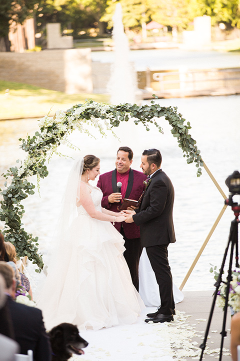 Avenue-of-the-arts-wedding-bride-and-groom-ceremony-close-up-bride-in-tulle-ball-gown-with-beaded-bodice-and-beaded-headband-groom-inblack-tuxedo-with-a-silver-vest-and-silver-bowtie