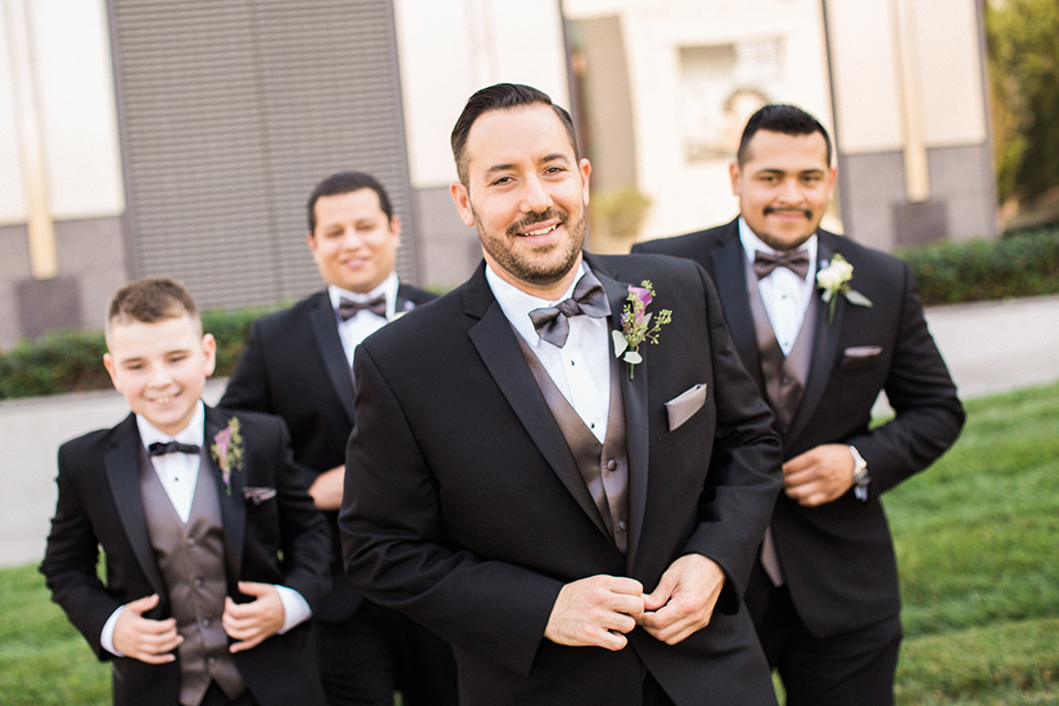 Avenue-of-the-arts-wedding-groomsmen-in-black-tuxedos-with-a-silver-vest-and-silver-bowtie