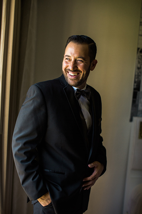 groom-smiling-groom-inblack-tuxedo-with-a-silver-vest-and-silver-bowtie